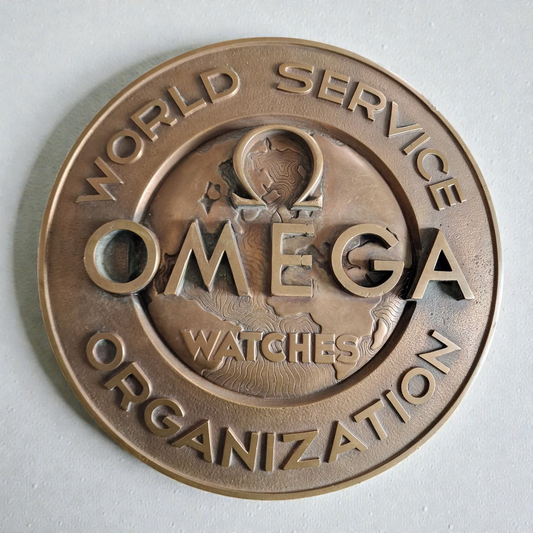 OMEGA . LETRERO BRONCE CONCESIONARIO