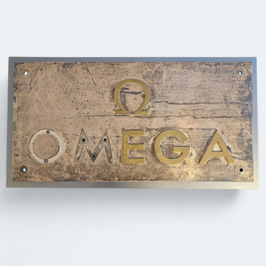 OMEGA . LETRERO DISTRIBUDOR OFICIAL
